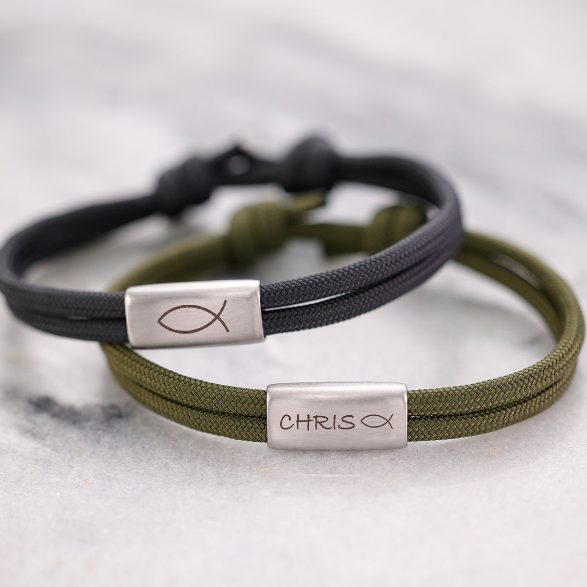 Personalisiertes Segeltau Armband mit Gravur zur Konfirmation – schwarzes und olivgrünes Band mit Name und Fischsymbol