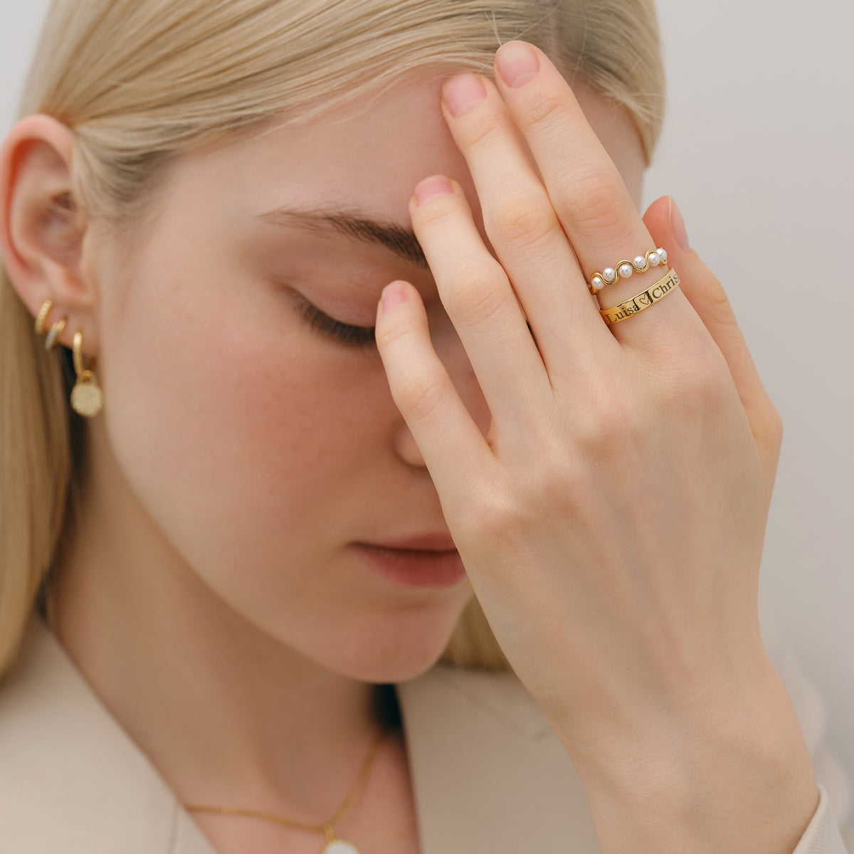 Frau trägt Minimalist Ring mit Gravur gestapelt mit Perlenring am Finger