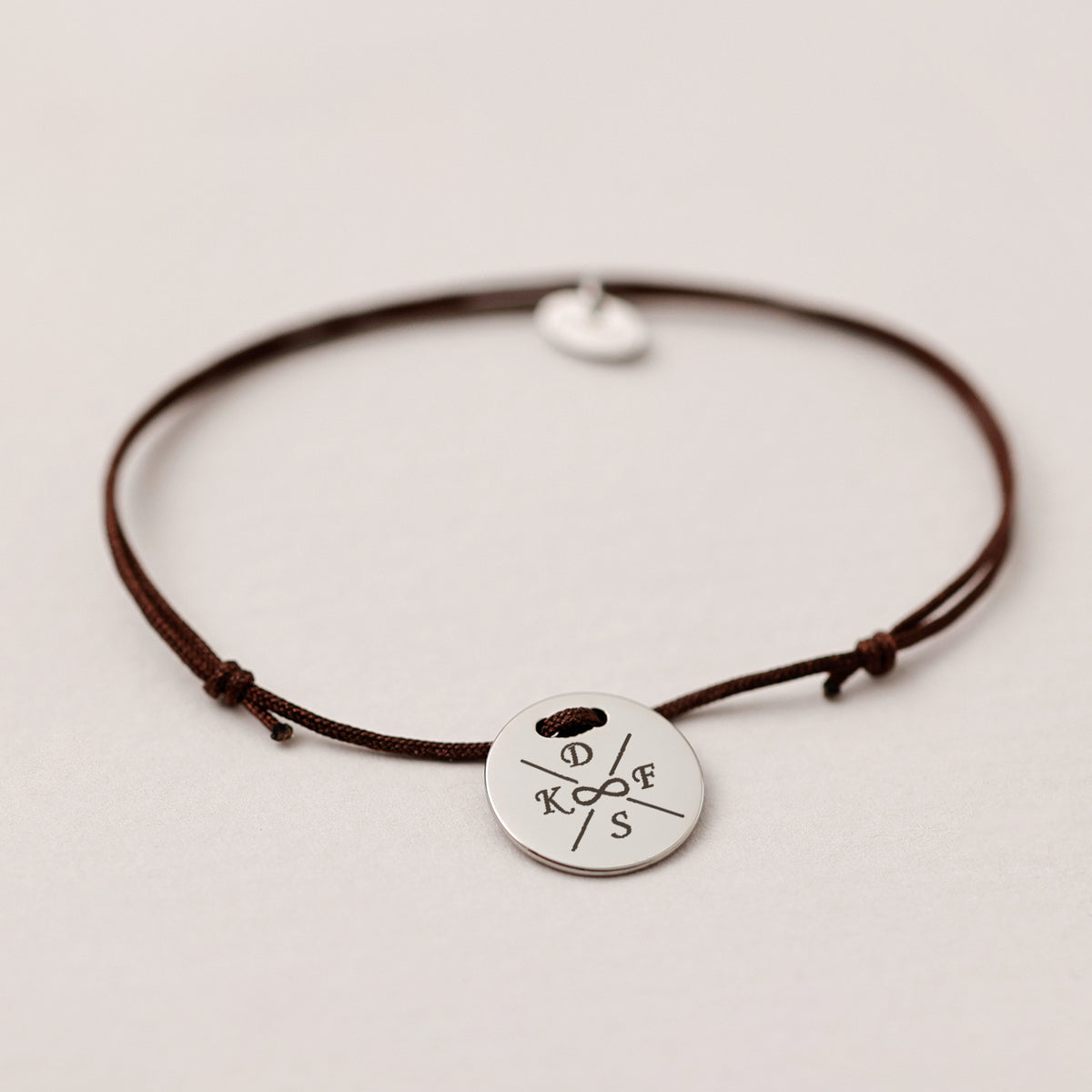 Unisex Armband mit Gravur, braune Kordel mit silbernem Plättchen und vier Initialen