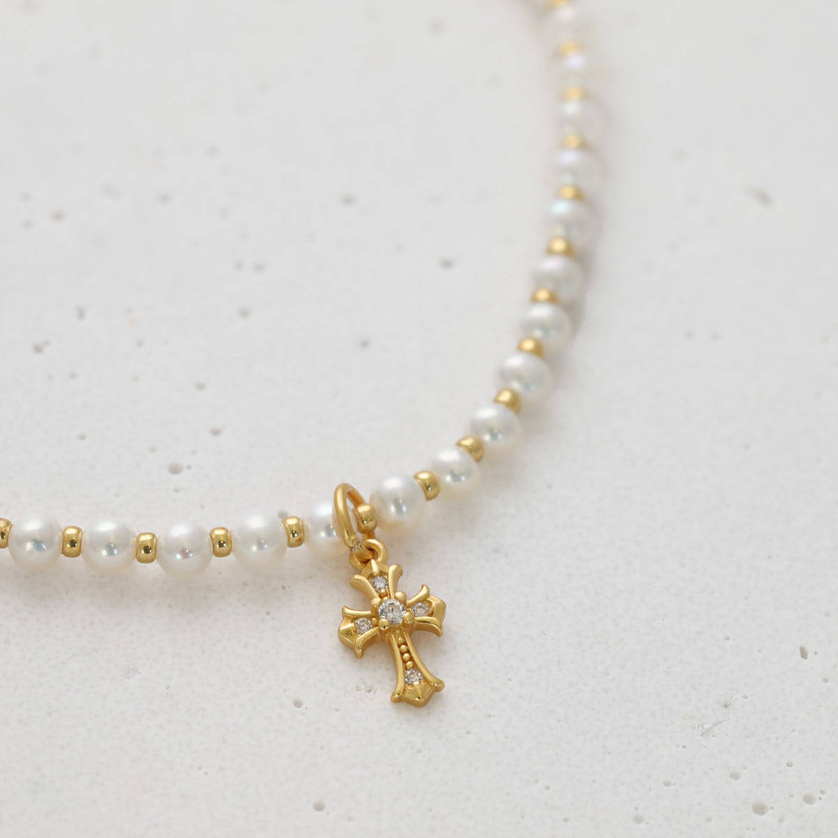 Süßwasserperlen Halskette mit funkelndem Kreuz in Gold, Nahaufnahme der Perlenkette in S-Form