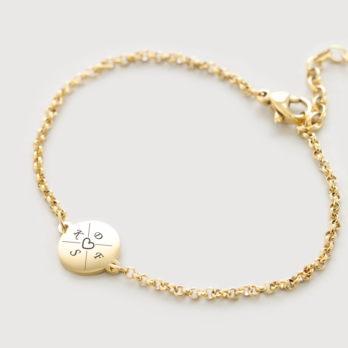 Personalisiertes Armband mit Gravur in Gold – rundes Plättchen mit Initialen und Herzsymbol in der Mitte