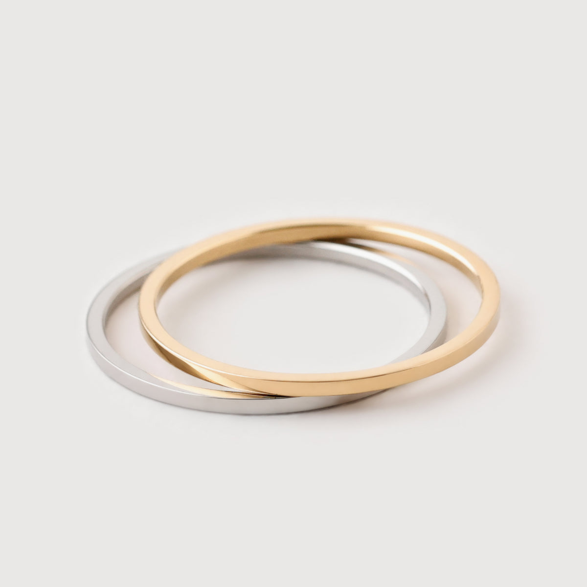 Feiner Stapelring in Gold und Silber – zwei Ringe ineinander verschlungen