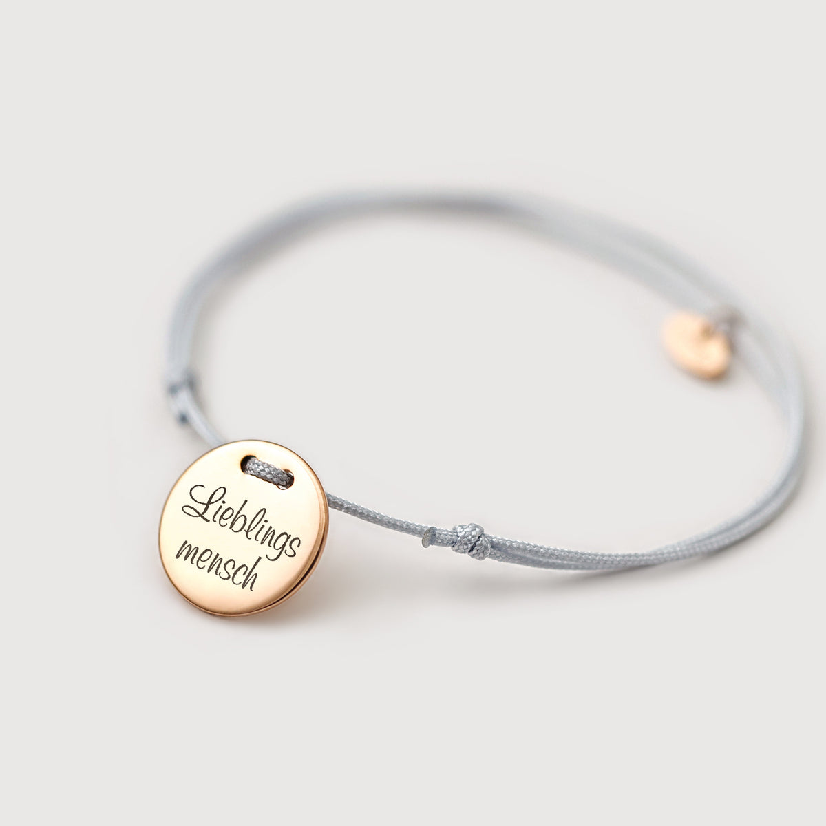 Unisex Armband mit Gravur, graue Kordel mit rundem Roségold-Plättchen 'Lieblingsmensch'