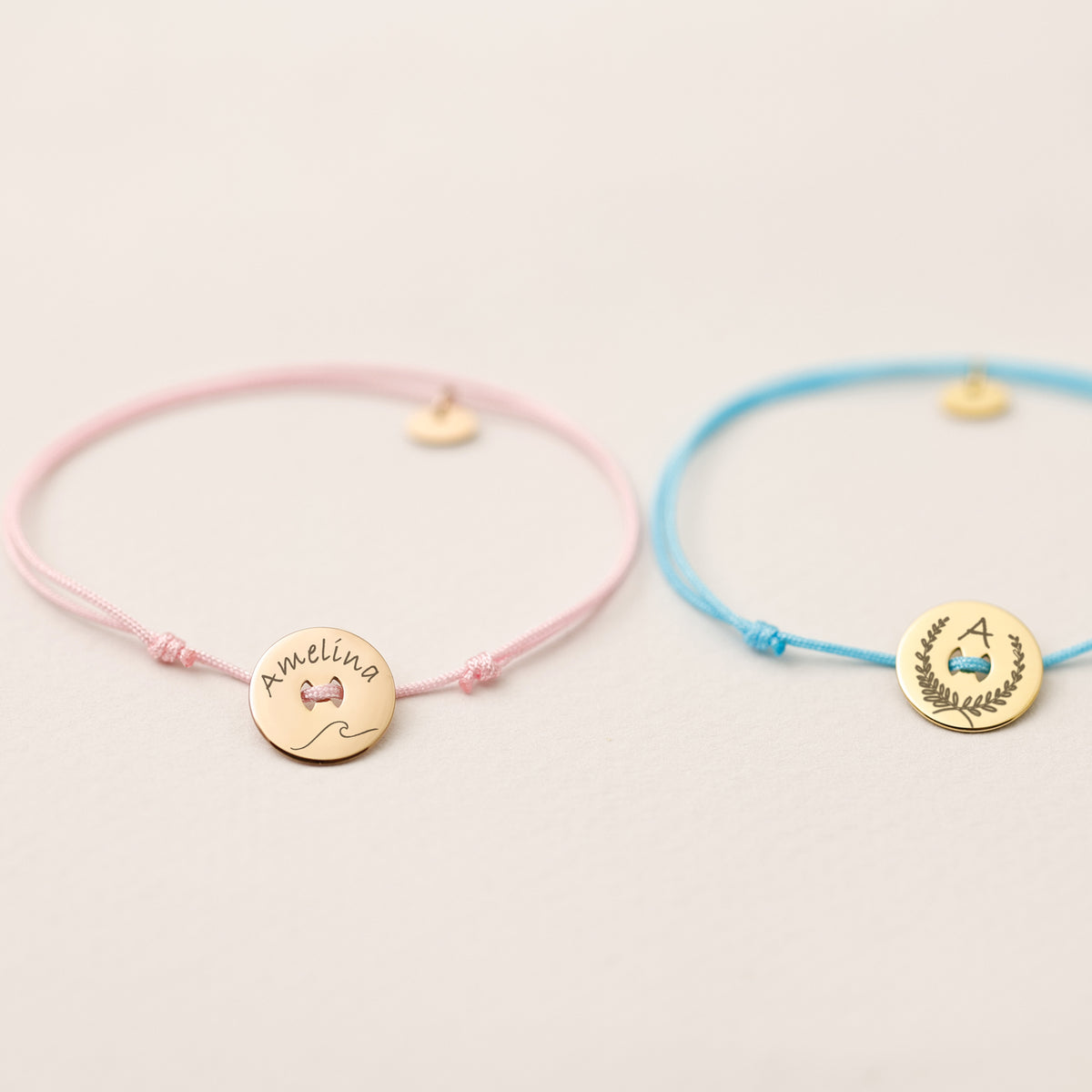 Zwei personalisierte Nylon Armbänder in Rosa und Blau, graviert mit Amelina und Initiale A